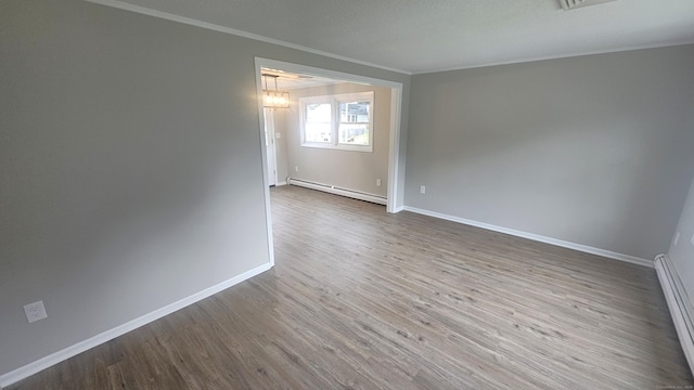 3 Norwood Ave, New London, CT 06320 - empty room with baseboard heating, ornamental molding, wood finished floors, and baseboards