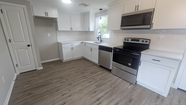 3 Norwood Ave, New London, CT 06320 - kitchen featuring stainless steel appliances, a sink, wood finished floors, and white cabinets