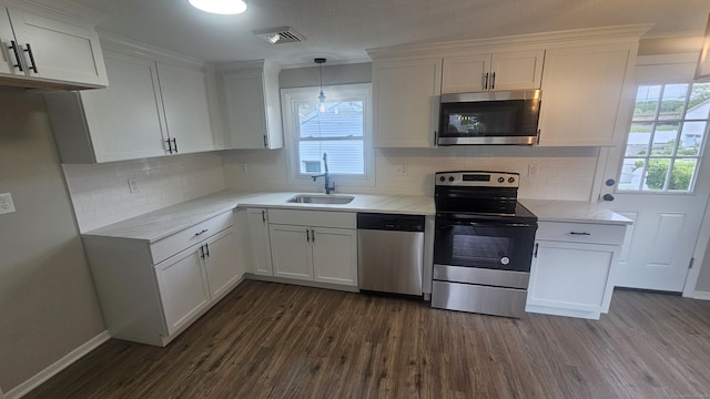 3 Norwood Ave, New London, CT 06320 - kitchen with stainless steel appliances, a sink, dark wood-style flooring, white cabinets, and crown molding