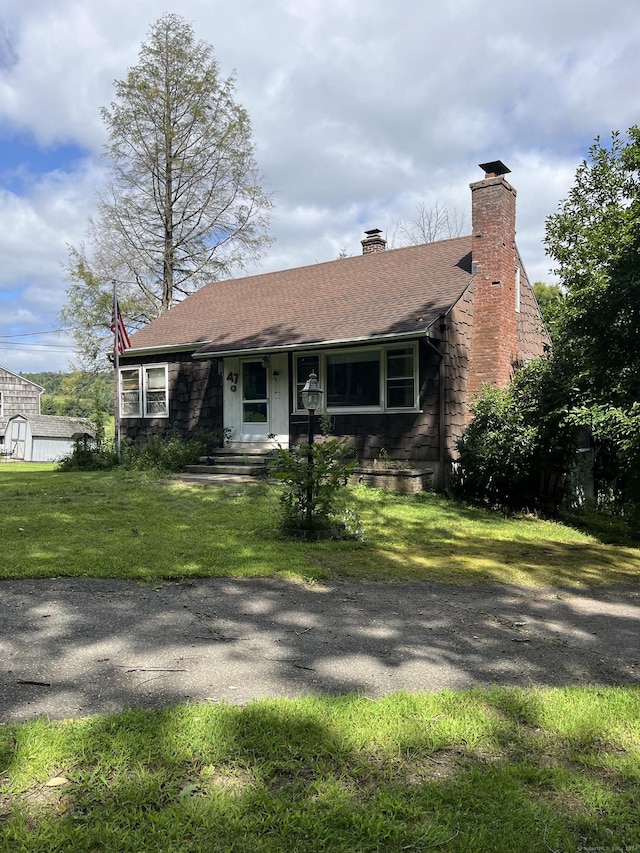 47 Devaux Rd, Torrington, CT 06790 - view of front of house featuring a front yard, a chimney, and a shingled roof
