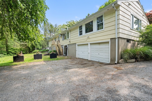 75 Skyview Dr, Trumbull, CT 06611 - view of front of house featuring asphalt driveway, a garage, and stairs