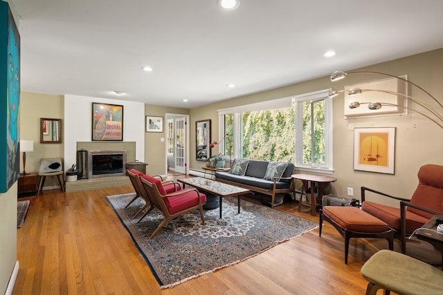 75 Skyview Dr, Trumbull, CT 06611 - living room featuring baseboard heating, wood finished floors, a brick fireplace, and recessed lighting