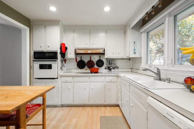 75 Skyview Dr, Trumbull, CT 06611 - kitchen with white appliances, under cabinet range hood, plenty of natural light, light countertops, and recessed lighting