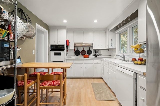 75 Skyview Dr, Trumbull, CT 06611 - kitchen with white appliances, a sink, light countertops, white cabinetry, and recessed lighting