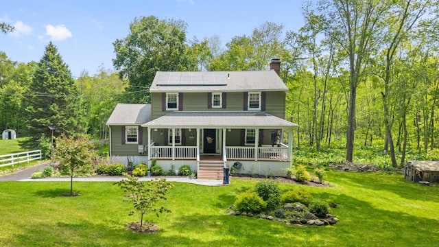 33 Crestview Dr, Brookfield, CT 06804 - view of front of property featuring covered porch, a chimney, solar panels, and a front lawn