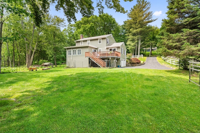 33 Crestview Dr, Brookfield, CT 06804 - view of green lawn with stairway, a wooden deck, and view of scattered trees