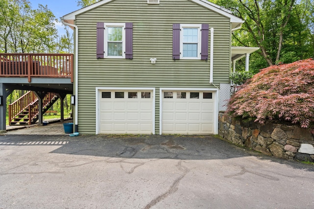 33 Crestview Dr, Brookfield, CT 06804 - view of home's exterior featuring asphalt driveway, an attached garage, stairway, and a deck