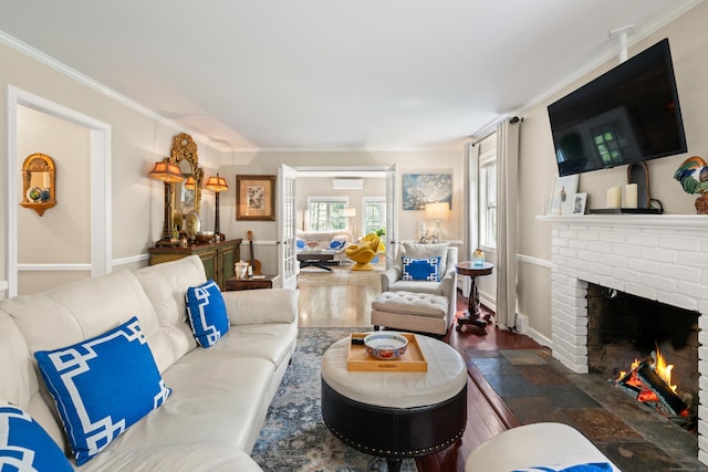 33 Crestview Dr, Brookfield, CT 06804 - living area featuring a fireplace, ornamental molding, a wall mounted AC, baseboards, and wood finished floors