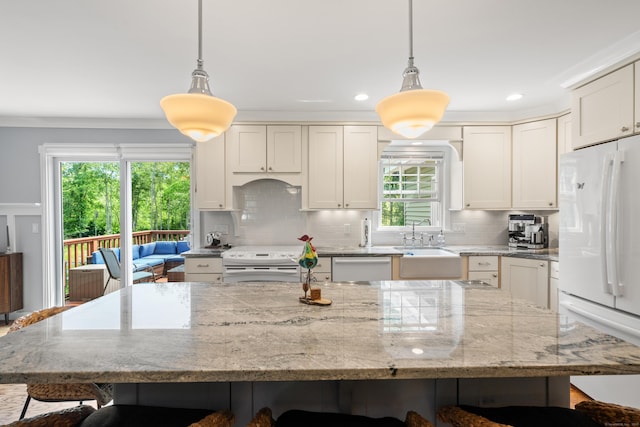 33 Crestview Dr, Brookfield, CT 06804 - kitchen featuring white appliances, a sink, a kitchen bar, tasteful backsplash, and plenty of natural light