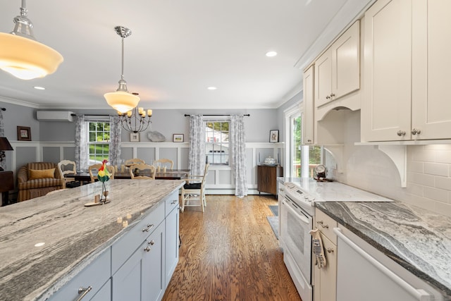 33 Crestview Dr, Brookfield, CT 06804 - kitchen featuring white appliances, a wall mounted AC, wood finished floors, pendant lighting, and a chandelier