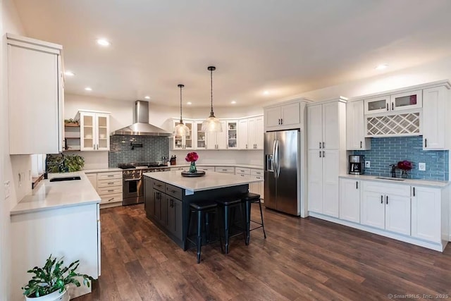 43B Saunders Hollow Rd, Old Lyme, CT 06371 - kitchen featuring stainless steel appliances, wall chimney range hood, tasteful backsplash, a center island, and light countertops