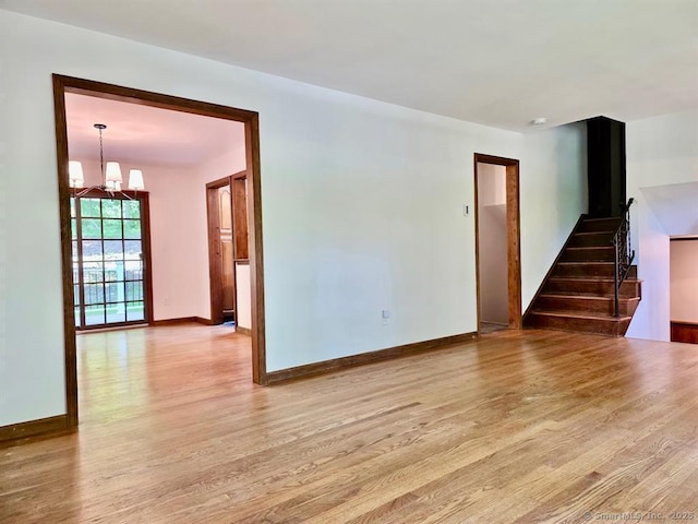687 Sprout Brook Rd, Putnam Valley, NY 10579 - unfurnished room with wood finished floors, a chandelier, stairs, and baseboards