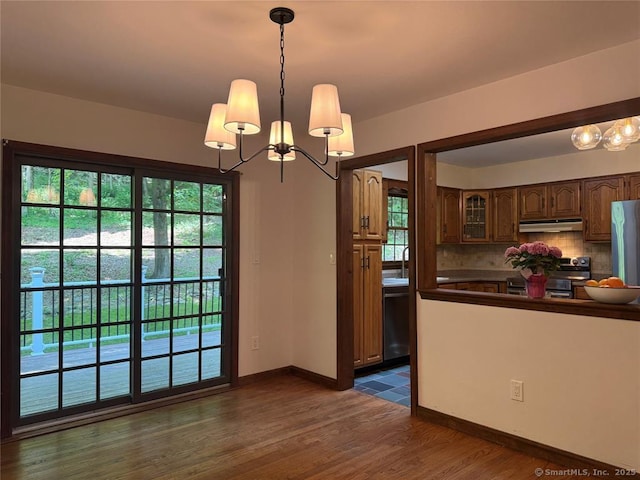 687 Sprout Brook Rd, Putnam Valley, NY 10579 - kitchen featuring under cabinet range hood, dishwasher, a chandelier, stainless steel range oven, and decorative backsplash