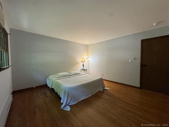 687 Sprout Brook Rd, Putnam Valley, NY 10579 - bedroom with wood finished floors, baseboards, and a baseboard radiator