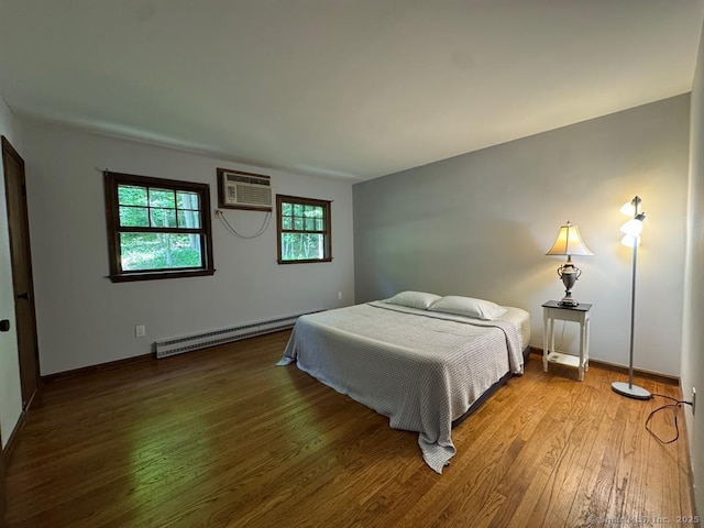 687 Sprout Brook Rd, Putnam Valley, NY 10579 - bedroom with baseboard heating, an AC wall unit, wood finished floors, and baseboards