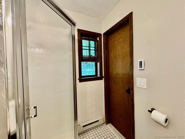 687 Sprout Brook Rd, Putnam Valley, NY 10579 - full bath with a baseboard radiator, a shower stall, and tile patterned flooring