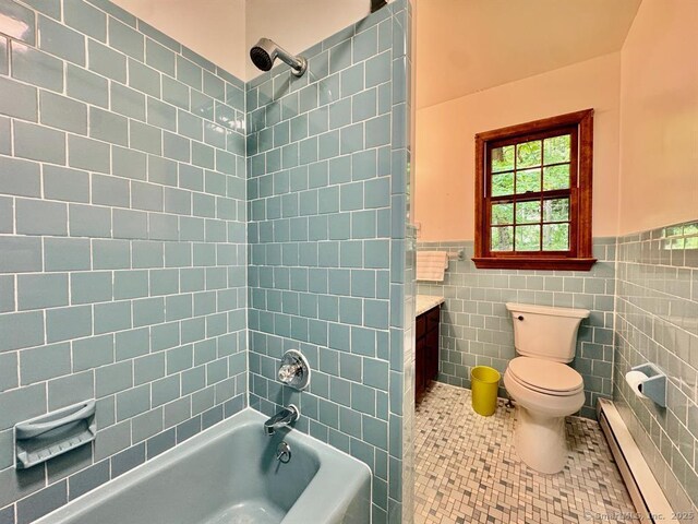 687 Sprout Brook Rd, Putnam Valley, NY 10579 - full bathroom featuring a baseboard heating unit, toilet, tile patterned flooring, vanity, and tile walls