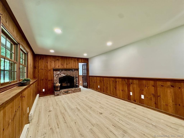 687 Sprout Brook Rd, Putnam Valley, NY 10579 - unfurnished living room featuring light wood-type flooring, wooden walls, wainscoting, recessed lighting, and a fireplace