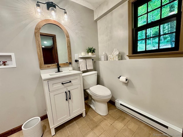 687 Sprout Brook Rd, Putnam Valley, NY 10579 - half bathroom featuring a baseboard heating unit, toilet, vanity, and baseboards
