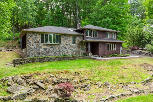 14 Old Bridge Rd W, New Fairfield, CT 06812 - view of front of home with a chimney, stone siding, a front yard, and roof with shingles