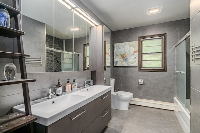 14 Old Bridge Rd W, New Fairfield, CT 06812 - full bathroom featuring tile walls, a baseboard radiator, toilet, double vanity, and enclosed tub / shower combo