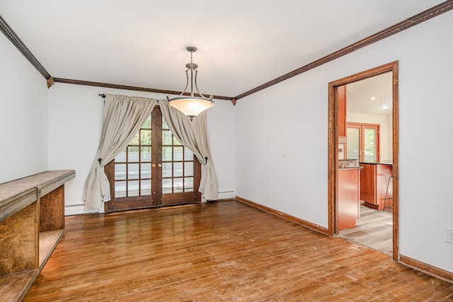 14 Old Bridge Rd W, New Fairfield, CT 06812 - unfurnished dining area with wood finished floors, crown molding, french doors, baseboards, and a baseboard heating unit