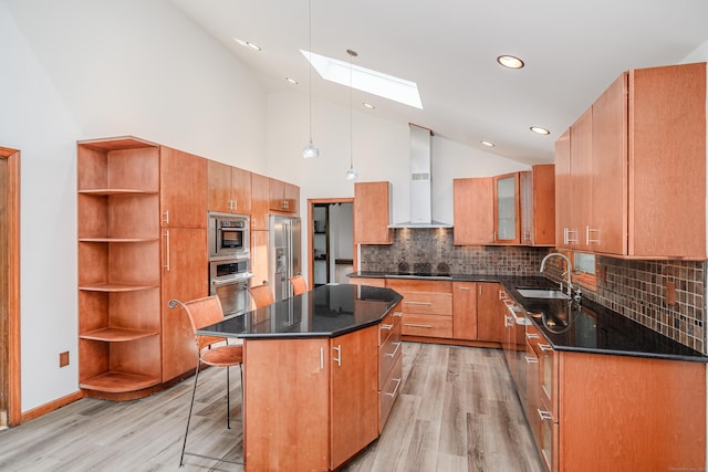 14 Old Bridge Rd W, New Fairfield, CT 06812 - kitchen featuring wall chimney exhaust hood, a skylight, a sink, stainless steel appliances, and light wood-style flooring