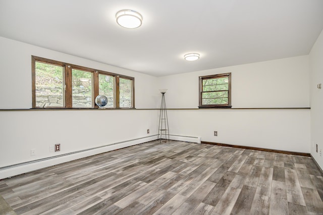 14 Old Bridge Rd W, New Fairfield, CT 06812 - unfurnished room with wood finished floors, a baseboard heating unit, and baseboards