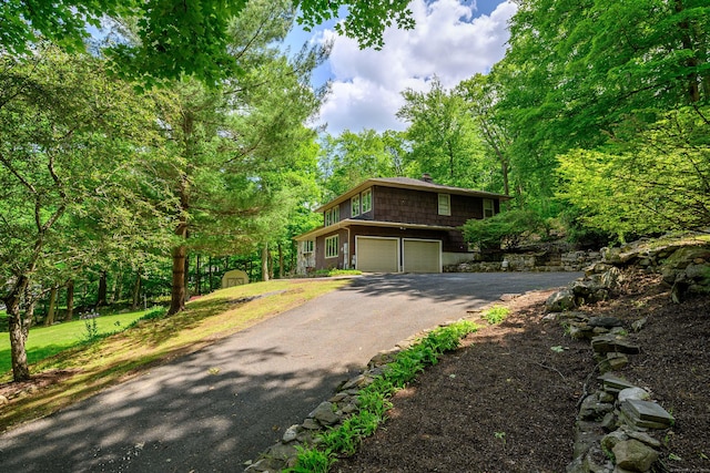 14 Old Bridge Rd W, New Fairfield, CT 06812 - view of front facade featuring driveway, an attached garage, and a chimney