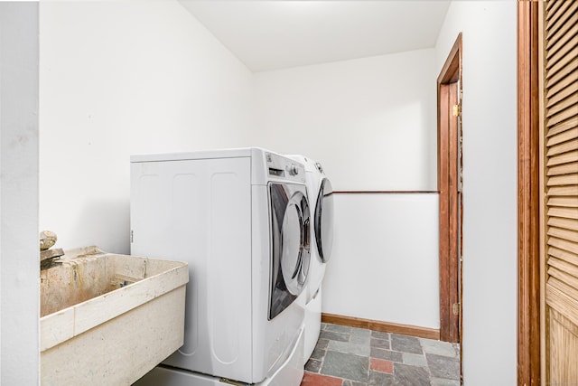 14 Old Bridge Rd W, New Fairfield, CT 06812 - laundry room with separate washer and dryer, dark stone finish floors, and baseboards