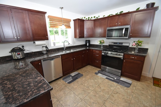 5 Old Village Cir, Windsor, CT 06095 - kitchen featuring appliances with stainless steel finishes, a sink, hanging light fixtures, dark stone countertops, and light tile patterned floors