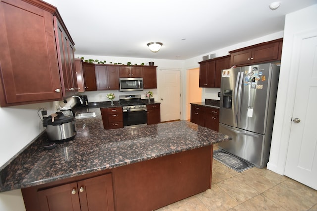 5 Old Village Cir, Windsor, CT 06095 - kitchen featuring stainless steel appliances, a sink, a peninsula, light tile patterned flooring, and dark stone countertops