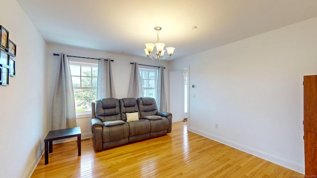 5 Old Village Cir, Windsor, CT 06095 - living room with a chandelier, light wood-style flooring, and baseboards