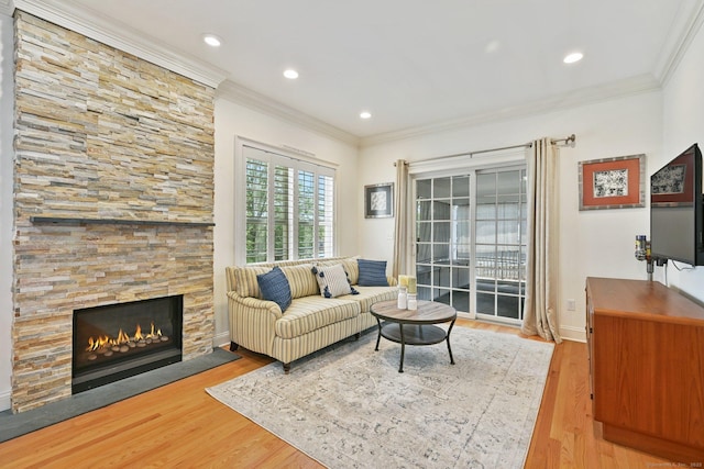 43 Harold St Unit B, Greenwich, CT 06807 - living area with ornamental molding, wood finished floors, a stone fireplace, baseboards, and recessed lighting