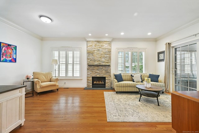 43 Harold St Unit B, Greenwich, CT 06807 - living room featuring crown molding, light wood-style floors, a stone fireplace, and recessed lighting