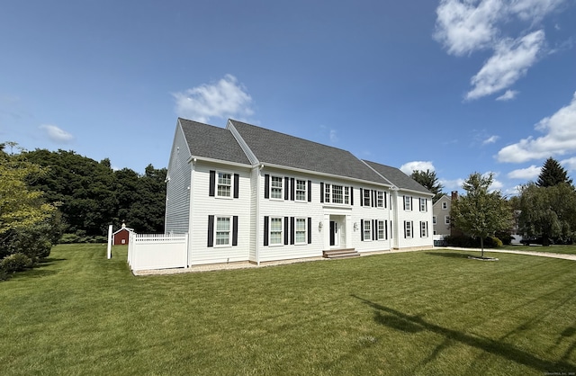 435 Maple Ave, Cheshire, CT 06410 - colonial house featuring a front lawn and a shingled roof