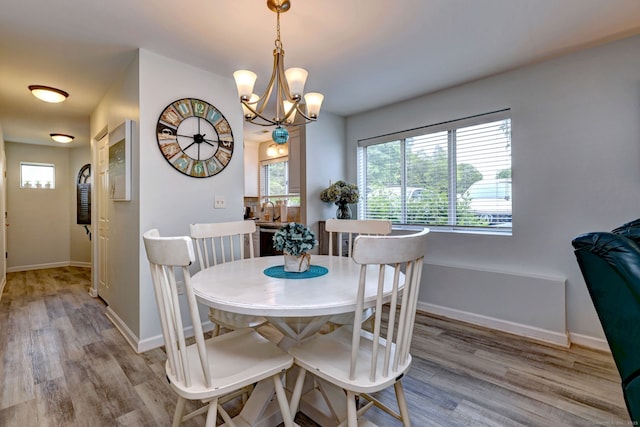 267 Melba St Apt D2, Milford, CT 06460 - dining room with light wood-style floors and a chandelier