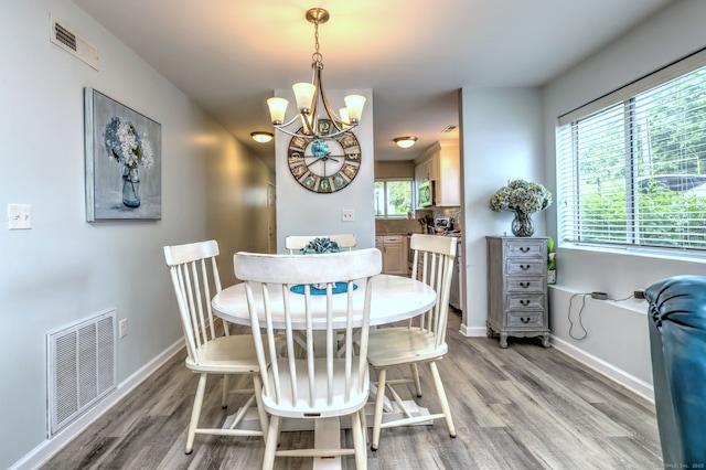 267 Melba St Apt D2, Milford, CT 06460 - dining room featuring light wood-style floors, a chandelier, and healthy amount of natural light