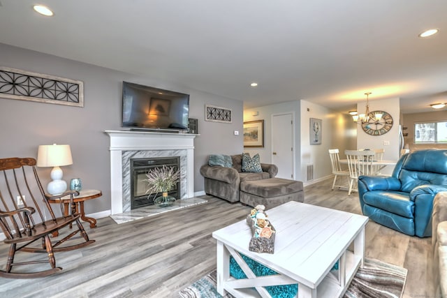 267 Melba St Apt D2, Milford, CT 06460 - living area with wood finished floors, recessed lighting, a chandelier, and a premium fireplace