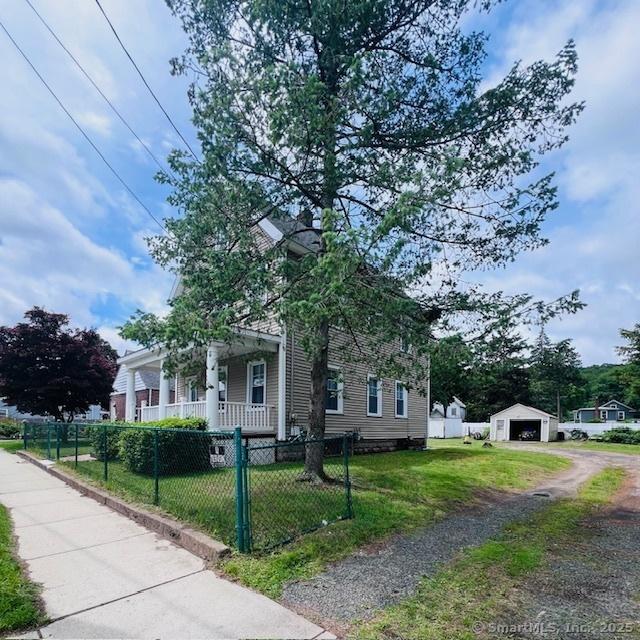 22 Webb St, Hamden, CT 06517 - view of front of property featuring a porch, a detached garage, an outbuilding, and driveway
