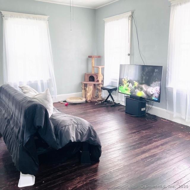 22 Webb St, Hamden, CT 06517 - living area featuring wood finished floors, crown molding, and baseboards