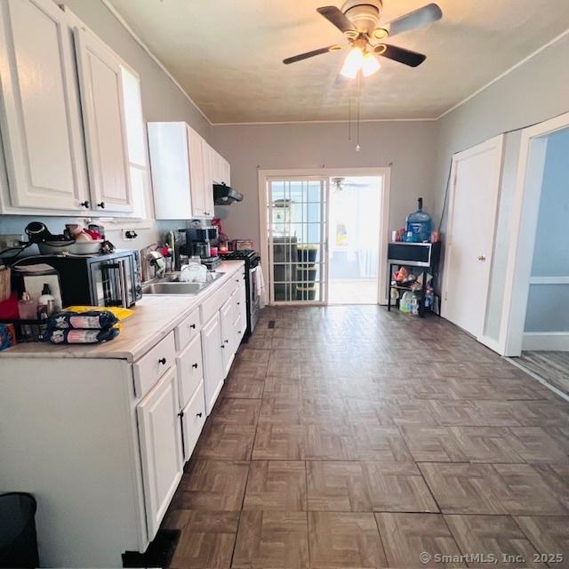 22 Webb St, Hamden, CT 06517 - kitchen with a ceiling fan, range with gas cooktop, white cabinetry, and light countertops