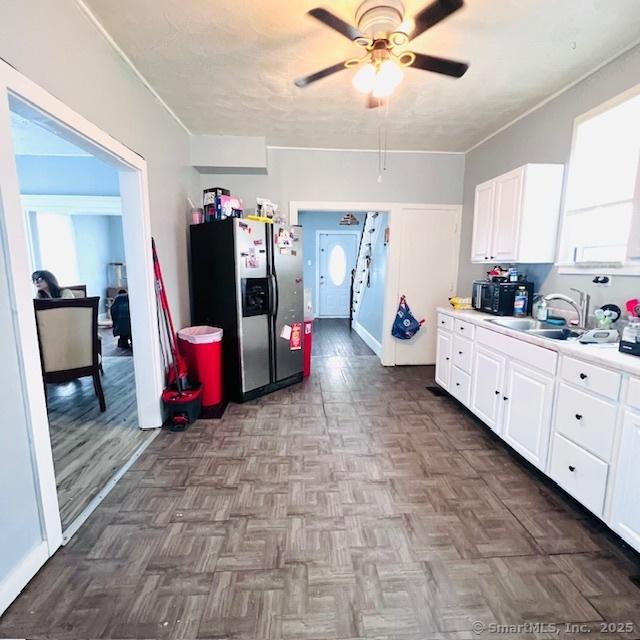 22 Webb St, Hamden, CT 06517 - kitchen with stainless steel refrigerator with ice dispenser, a sink, ceiling fan, and white cabinets