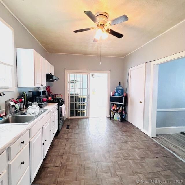 22 Webb St, Hamden, CT 06517 - kitchen featuring range with gas cooktop, a sink, ceiling fan, white cabinetry, and light countertops
