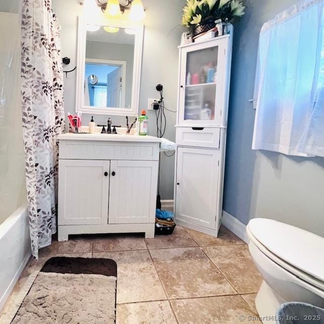 22 Webb St, Hamden, CT 06517 - bathroom featuring vanity, toilet, tile patterned floors, shower / bath combo with shower curtain, and baseboards