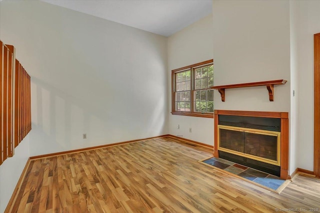 10 Crown Rdg Unit 10, Newington, CT 06111 - unfurnished living room featuring wood finished floors, a fireplace with flush hearth, and baseboards