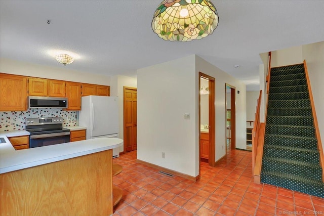 10 Crown Rdg Unit 10, Newington, CT 06111 - kitchen with stainless steel appliances, light countertops, light tile patterned flooring, and decorative backsplash