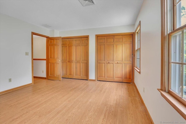 10 Crown Rdg Unit 10, Newington, CT 06111 - unfurnished bedroom with light wood finished floors, baseboards, and multiple closets