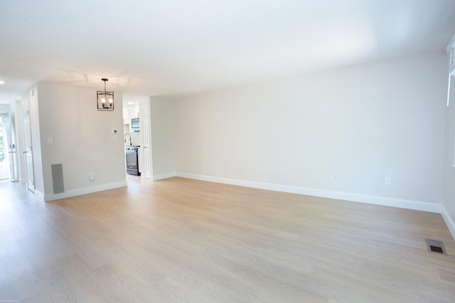 14 Hubbard Run Dr Unit 14, Glastonbury, CT 06033 - unfurnished room featuring a chandelier, light wood-style floors, and baseboards