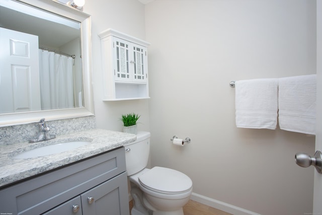 14 Hubbard Run Dr Unit 14, Glastonbury, CT 06033 - bathroom featuring vanity, toilet, baseboards, and wood finished floors